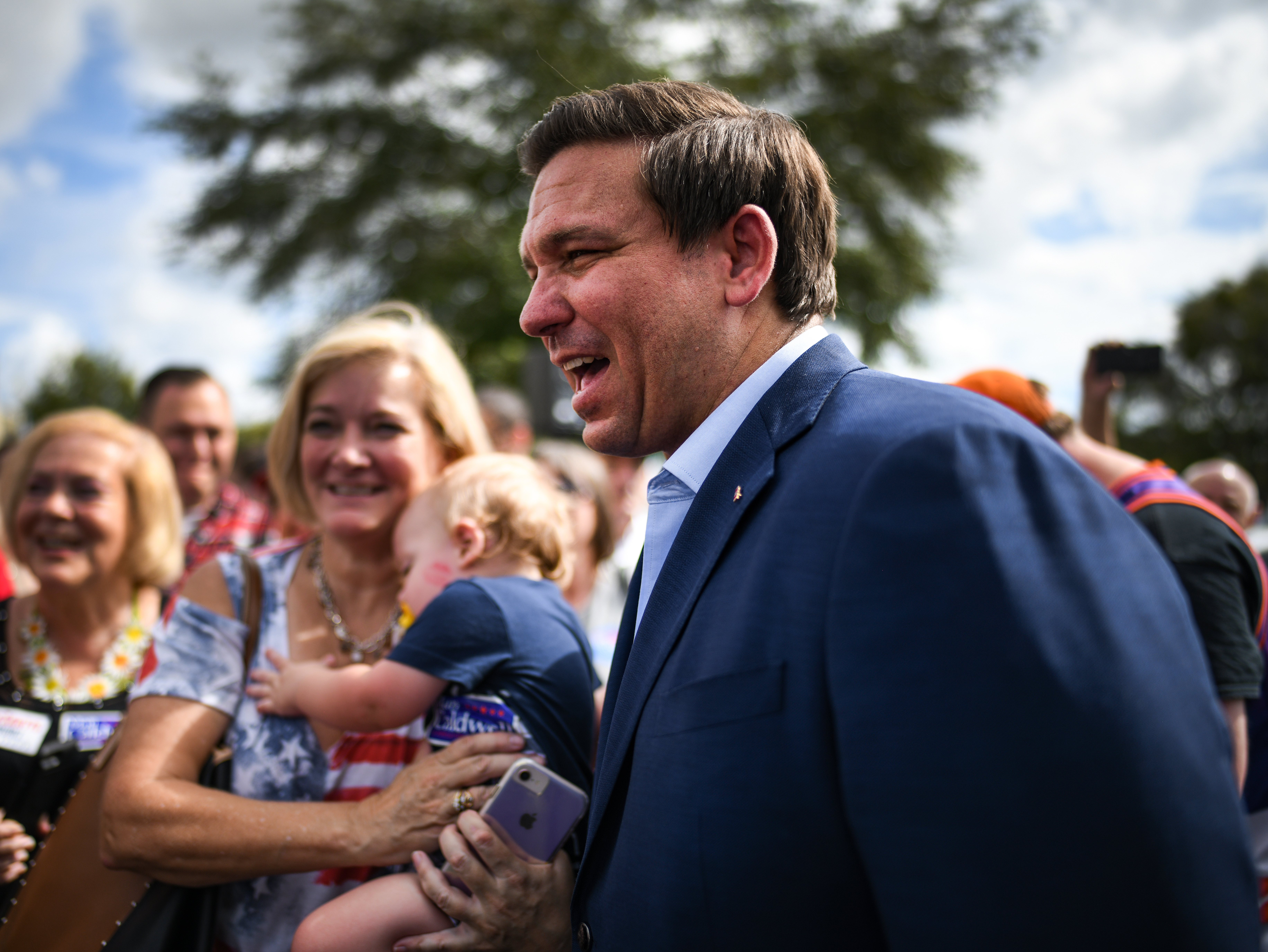caption: Ron DeSantis meets with supporters at a rally Monday in Orlando, Fla.