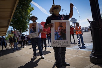caption: Emmanuel Anguiano-Mendoza, left, and Agustin LÃ³pez hold posters featuring featuring David Cruz, a worker who died on May 30.Enrique PÃ©rez de la Rosa/NWPB