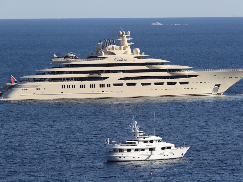 caption: The luxury superyacht Dilbar sails off the coast of Monaco in 2017.