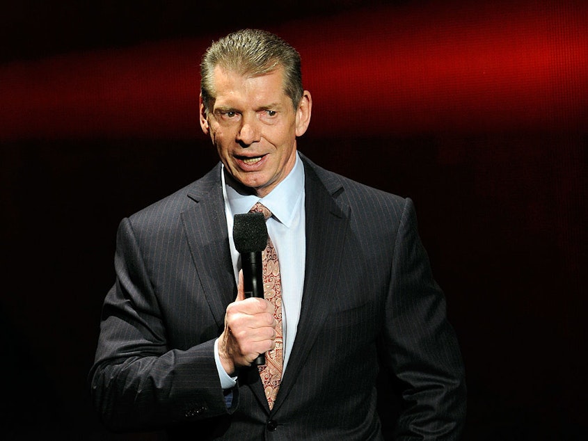 caption: WWE Chairman and CEO Vince McMahon speaks at a news conference in January 2014.