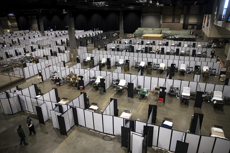 caption: U.S. Army soldiers set up a military field hospital inside CenturyLink Field Event Center on Sunday, April 5, 2020, in Seattle. The 250-bed hospital for non COVID-19 patients was deployed by soldiers from the 627th Army Hospital from Fort Carson, Colorado, as well as soldiers from Joint Base Lewis-McChord. 