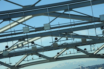 caption: Cameras on the Highway 520 bridge take pictures of license plates as vehicles pass to assess tolls.
