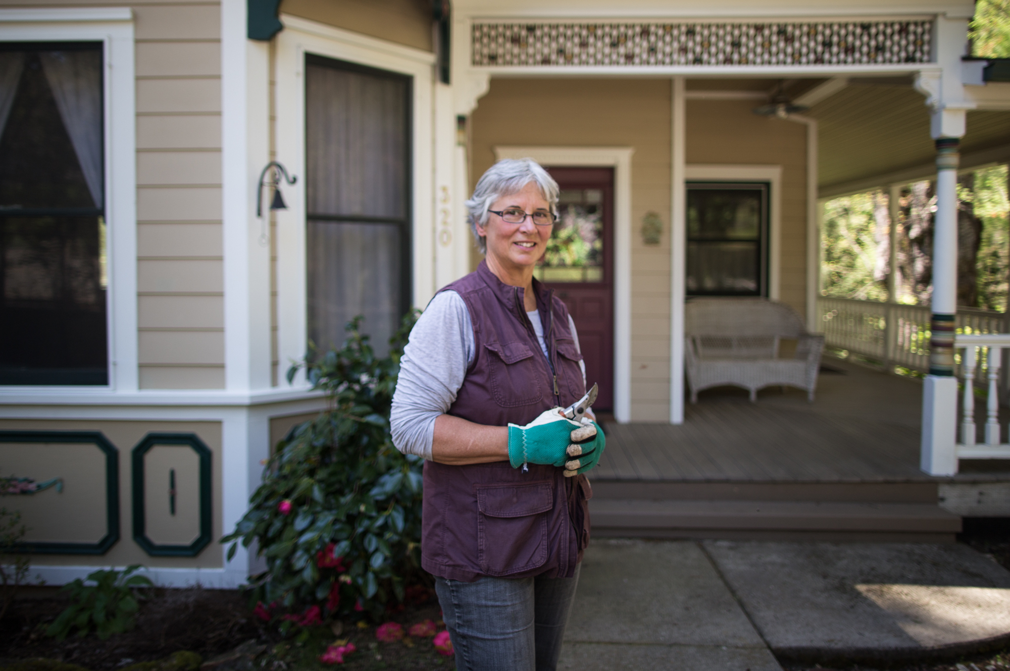 caption: Christine Bottaro and her husband have hardened their 164-year-old house in Nevada City. When the house was renovated, they used cement composite siding and plastic composite materials for the wraparound deck instead of wood. They also installed a rock garden in the front in lieu of potentially flammable plants. The rocks help retain moisture in the yard and keep the ground cool, Bottaro says.