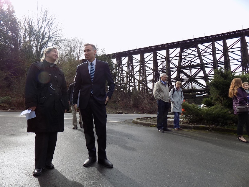 caption: Christie True, who runs the King County parks department, stands with county executive Dow Constantine before the Wilburton Trestle in Bellevue. A new proposal would put a bike and pedestrian trail atop the historic trestle.