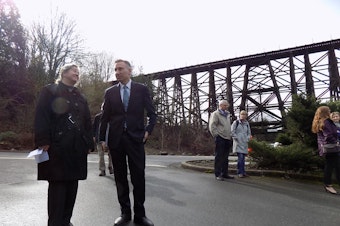 caption: Christie True, who runs the King County parks department, stands with county executive Dow Constantine before the Wilburton Trestle in Bellevue. A new proposal would put a bike and pedestrian trail atop the historic trestle.