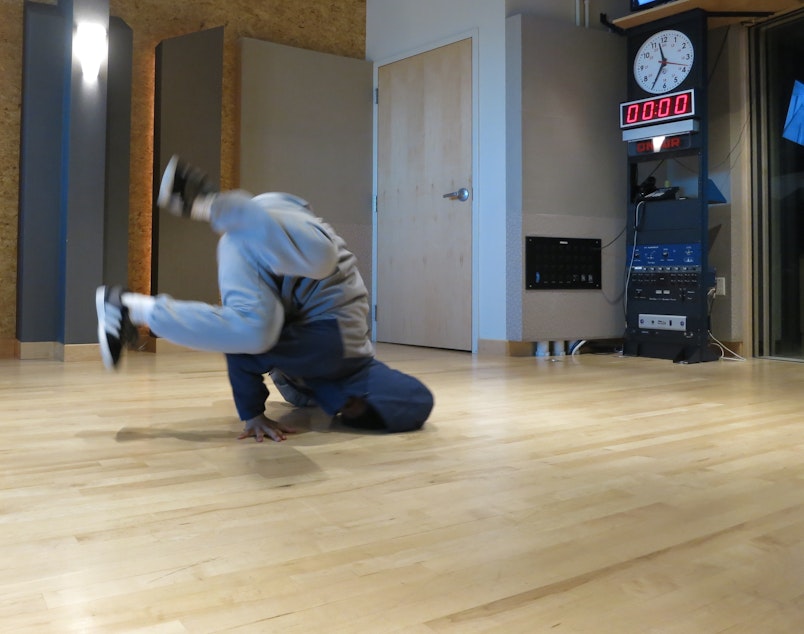 caption: Krubel Amare shows off a head spin in the KUOW studio.