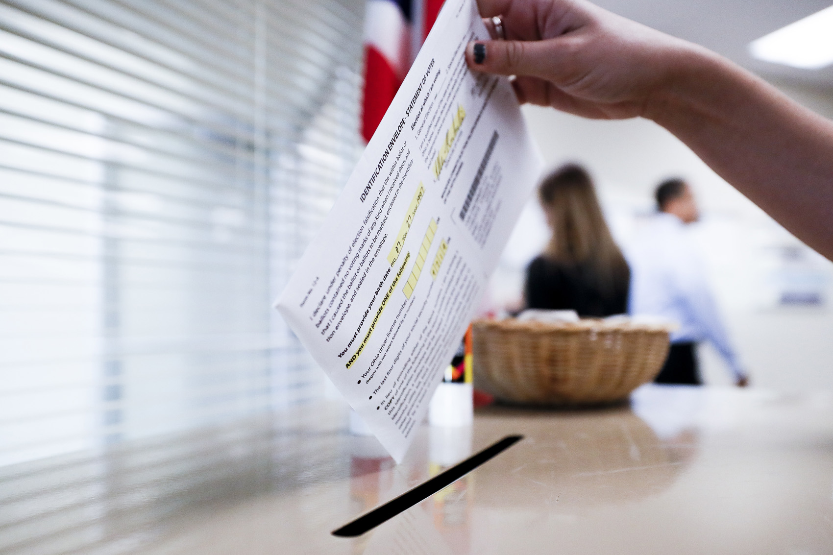 caption: A voter casts their ballot on the first day of early voting at the Hamilton County Board of Elections, Wednesday, Oct. 10, 2018, in Cincinnati. In-person voting has begun in swing-state Ohio for the Nov. 6 elections for governor, U.S. Senate, House seats and a host of other state and local offices and issues. Registration closed Tuesday, and county voting centers opened Wednesday morning. (AP Photo/John Minchillo)