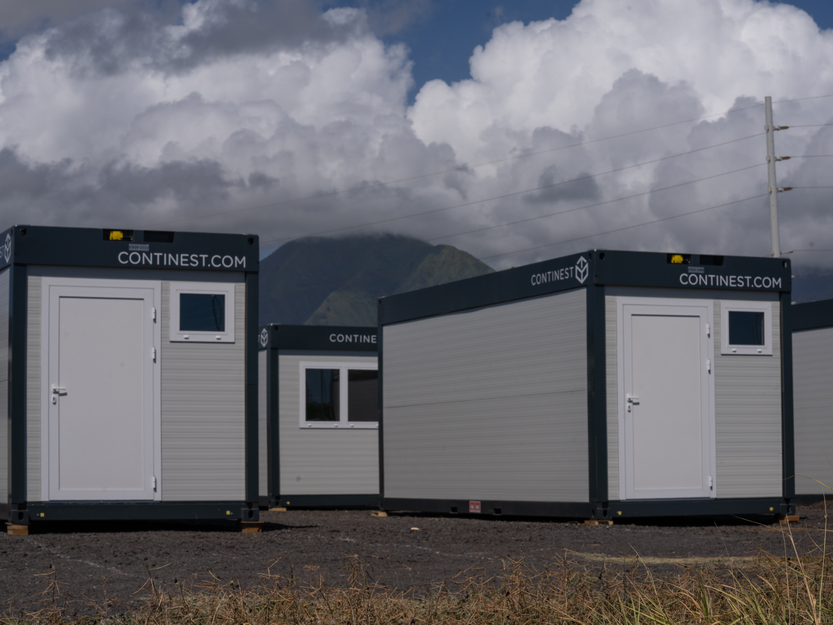 caption: Modular container homes are set up in Kahului, Hawaii. A pop-up village of the buildings is in the process of being created by a local organization, the Family Life Center.