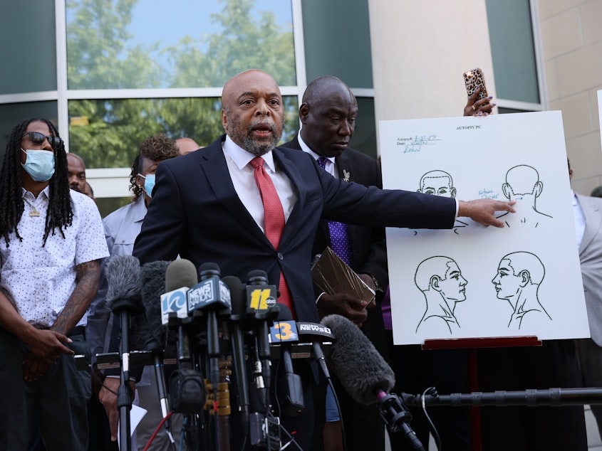 caption: Speaking to reporters on April 27 in Elizabeth City, N.C., Wayne Kendall, one of the lawyers representing the family of Andrew Brown Jr., points to an autopsy chart showing where Brown was shot.