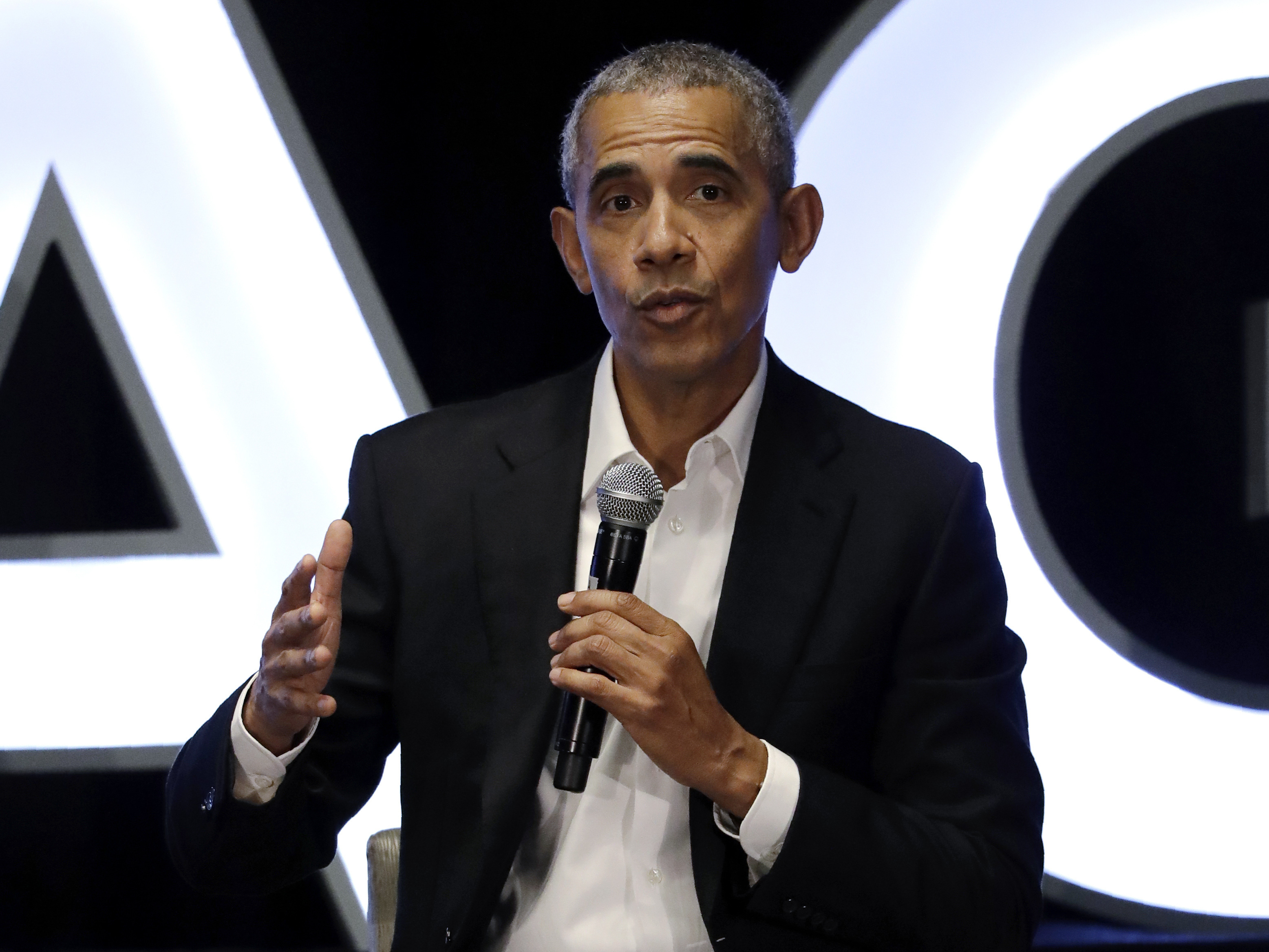 caption: Former president Barack Obama talks during a panel with NBA players Chris Paul, Kevin Love and Giannis Antetokounmpo and sports analyst Michael Wilbon in Chicago on Saturday, Feb. 15, 2020. (AP Photo/Nam Y. Huh)