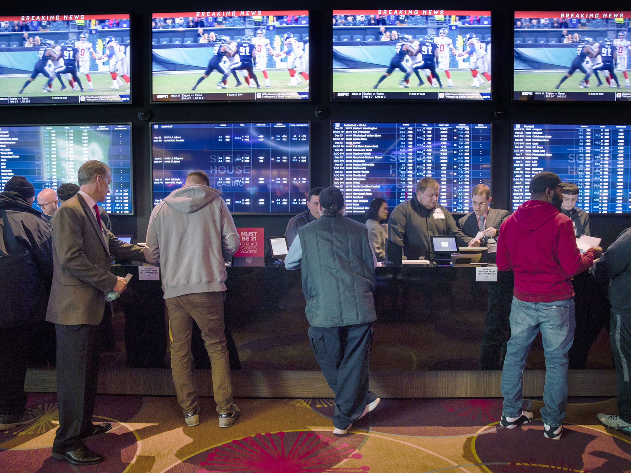 caption: Gamblers place bets in the temporary sports-betting area at the SugarHouse Casino in Philadelphia on Dec. 13, 2018. An estimated 17.6 million people are expected to place a bet on Sunday's Super Bowl online or in person at a sportsbook.