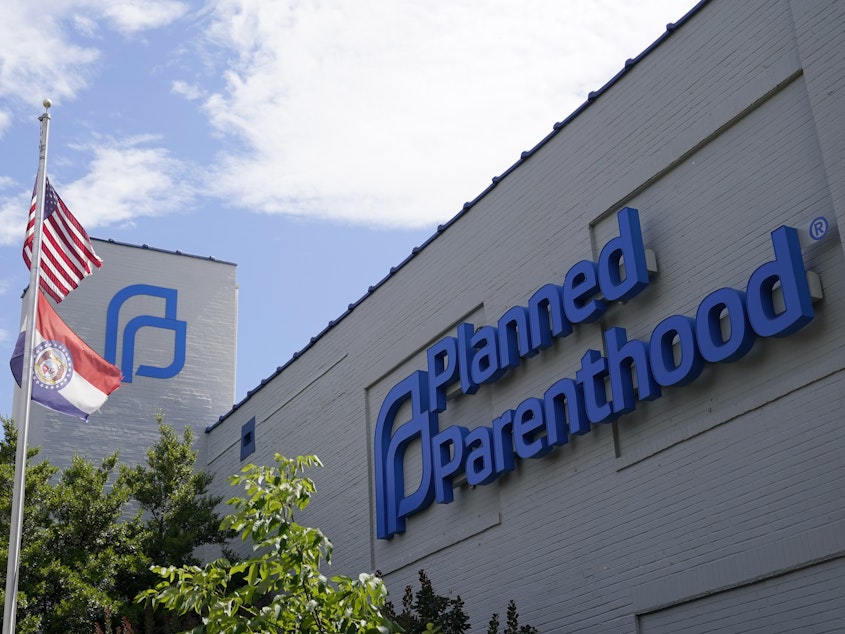 caption: Missouri and American flags fly outside Planned Parenthood in June in St. Louis.