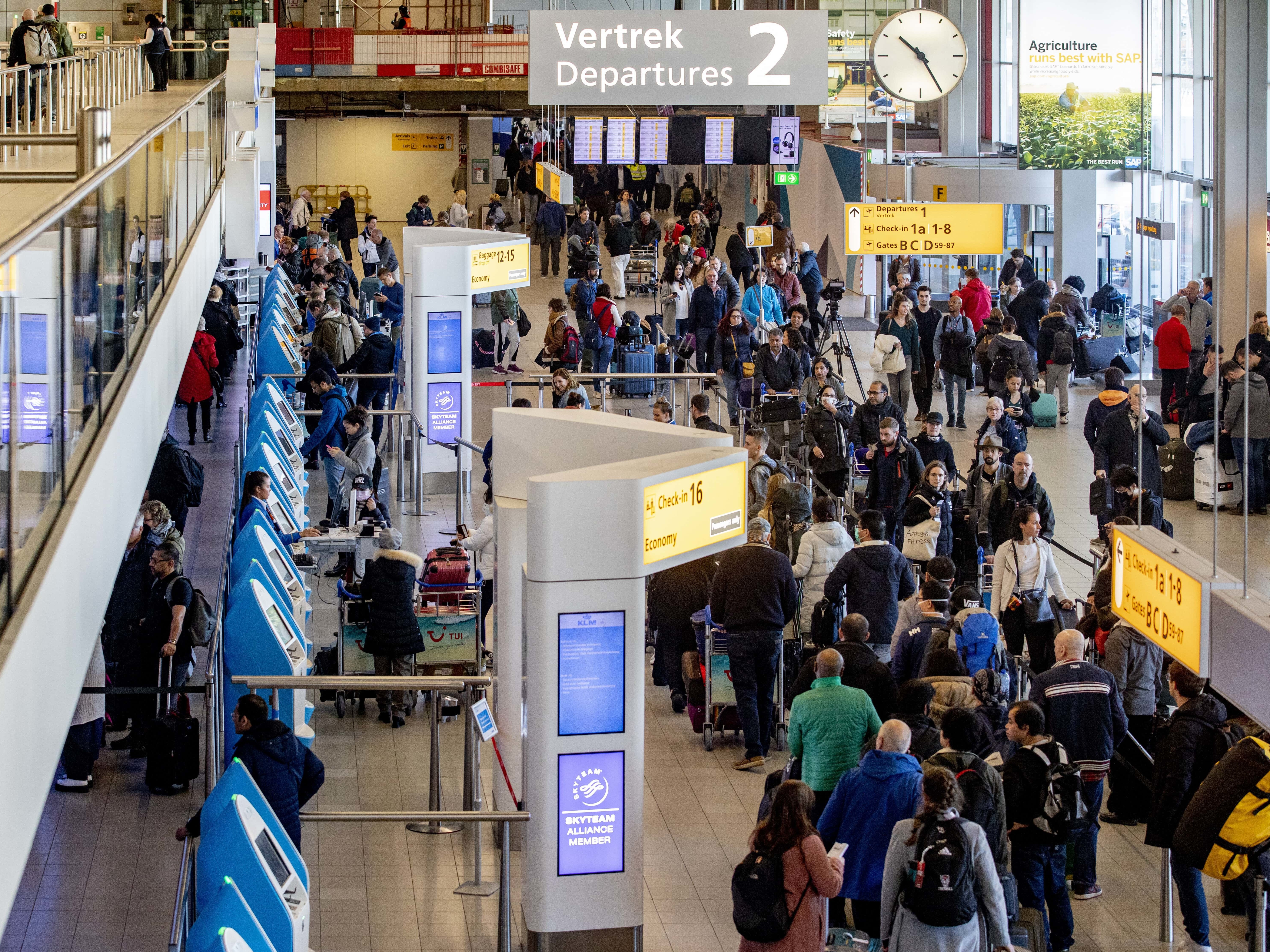 caption: Passengers hoping to change their flights to the U.S. wait in long lines at Amsterdam Airport Schiphol in the Netherlands after President Trump announced new restrictions on travel from Europe.