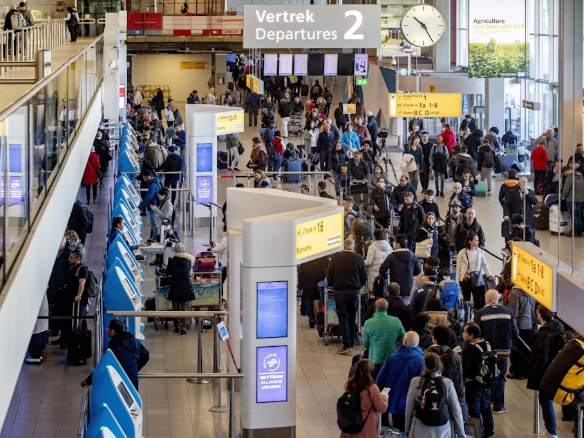 caption: Passengers hoping to change their flights to the U.S. wait in long lines at Amsterdam Airport Schiphol in the Netherlands after President Trump announced new restrictions on travel from Europe.