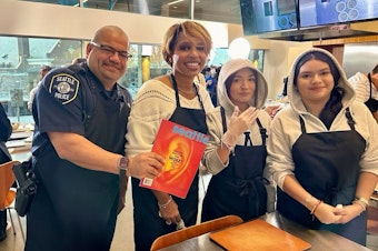 caption: Seattle Police Chief Adrian Diaz and former Police Chief Carmen Best pose with a couple teenagers during the Cooking with the Chief event on Saturday, Nov. 4. This event is funded by a grant in partnership with Seattle Magazine and PCC.