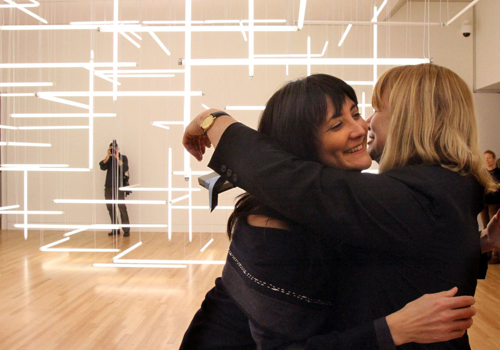 caption: Freelance visual-arts curator Yoko Ott (left) hugs Jo-Anne Birnie Danzker, director of the Frye Art Museum, after giving her a present on Danzker's birthday.  