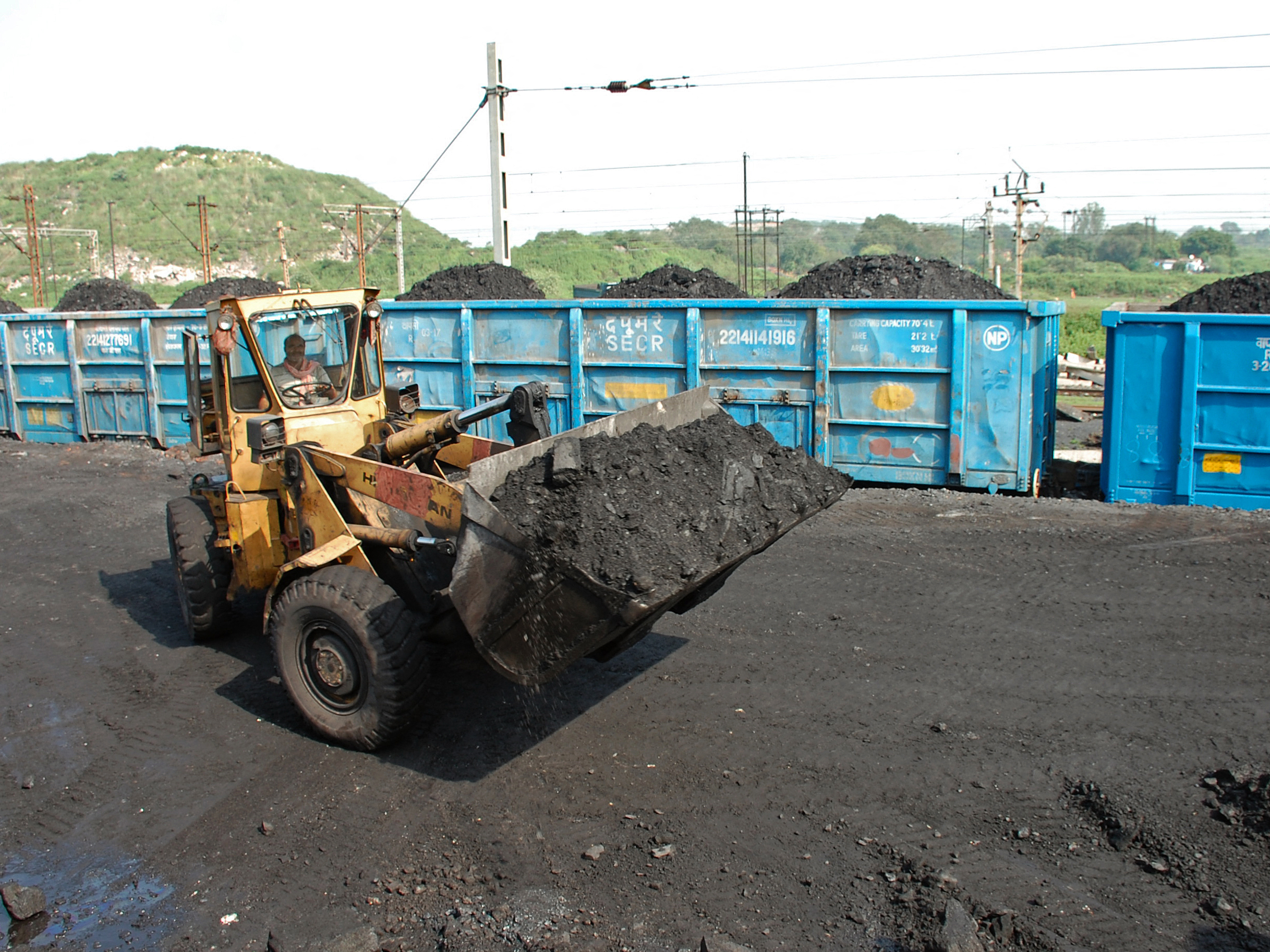 caption: A bulldozer loads coal onto railway wagons at the Jharia coalfield in Dhanbad in India's Jharkhand state.