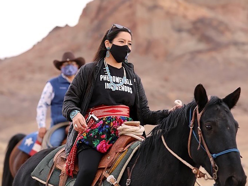 caption: Allie Young, a Diné woman on the Navajo Nation in Arizona, is among a group of Native Americans riding on horseback to the polls on Election Day.