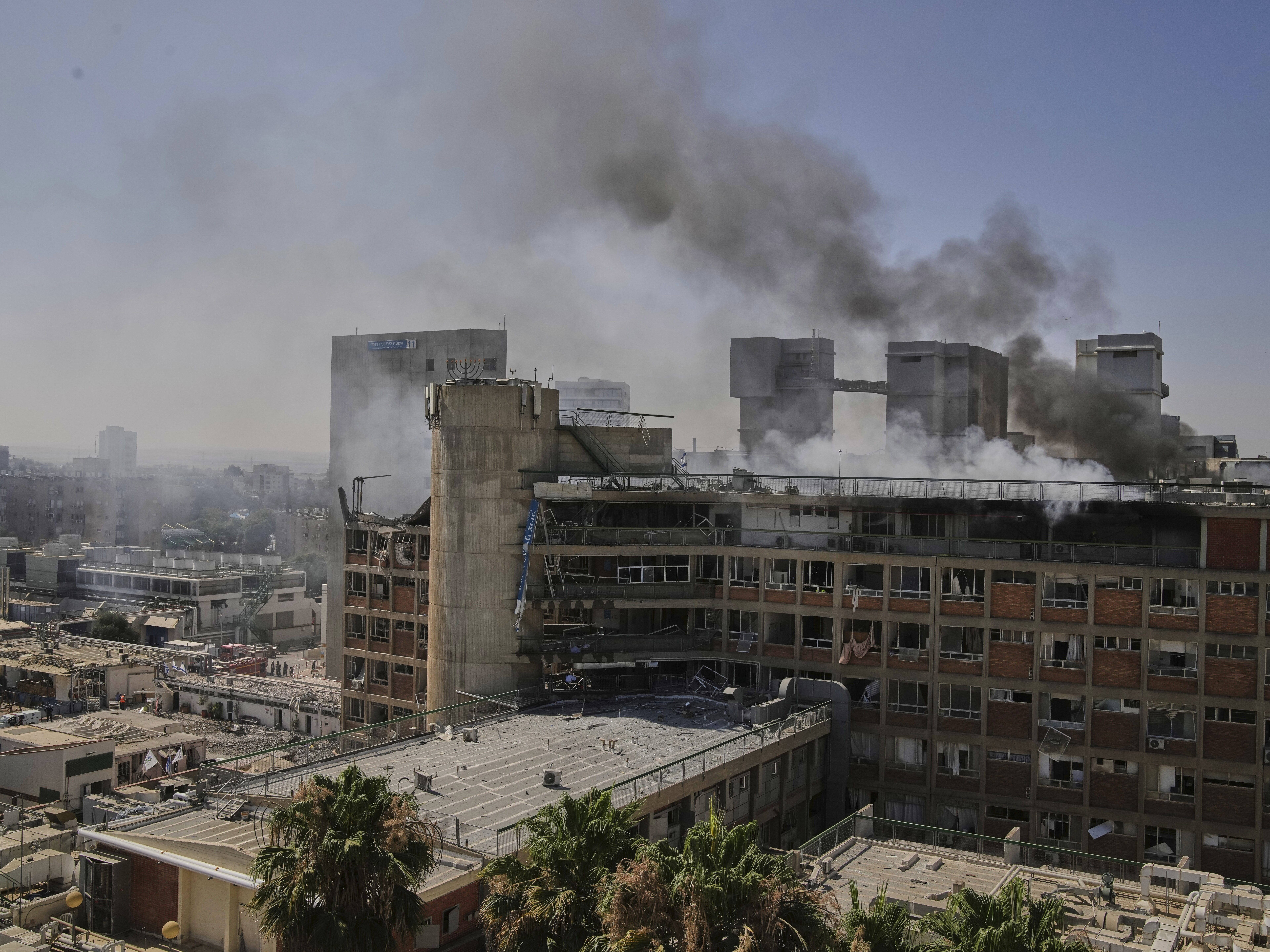 caption: Smokes rises from a building of the Soroka hospital complex after it was hit by a missile fired from Iran in Be'er Sheva, Israel on Thursday.