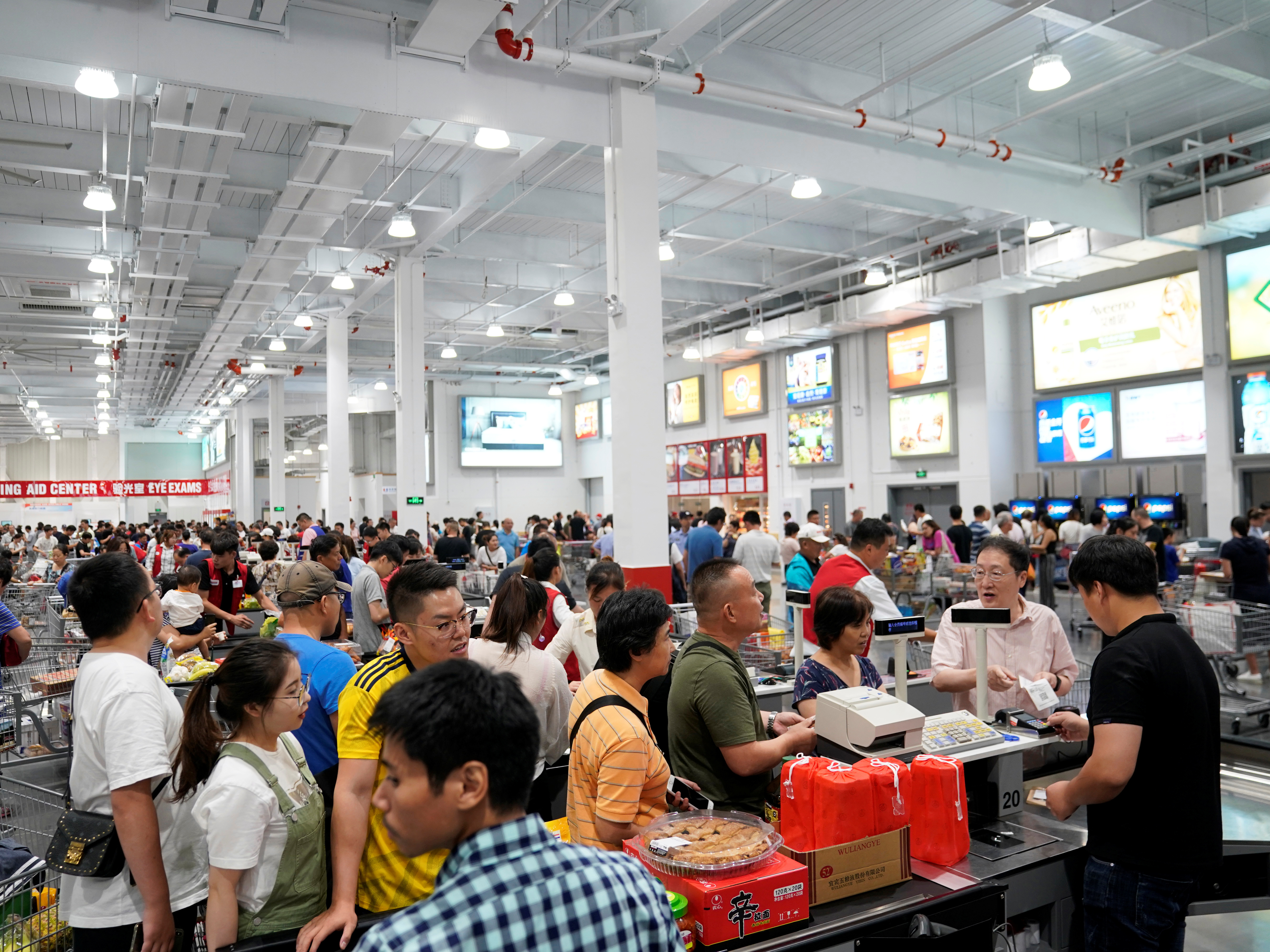 caption: Crowds streamed into the new Costco location, which opened on Tuesday in Shanghai.