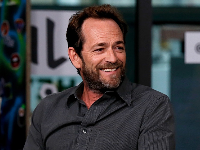 caption: Luke Perry, seen here last October during a press appearance for the TV series <em>Riverdale</em>, has died following a massive stroke, his publicist said Monday.