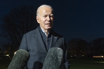 caption: President Biden answers a reporter's question as he walks from Marine One upon arrival on the South Lawn of the White House, Dec. 20, 2023, in Washington, D.C.