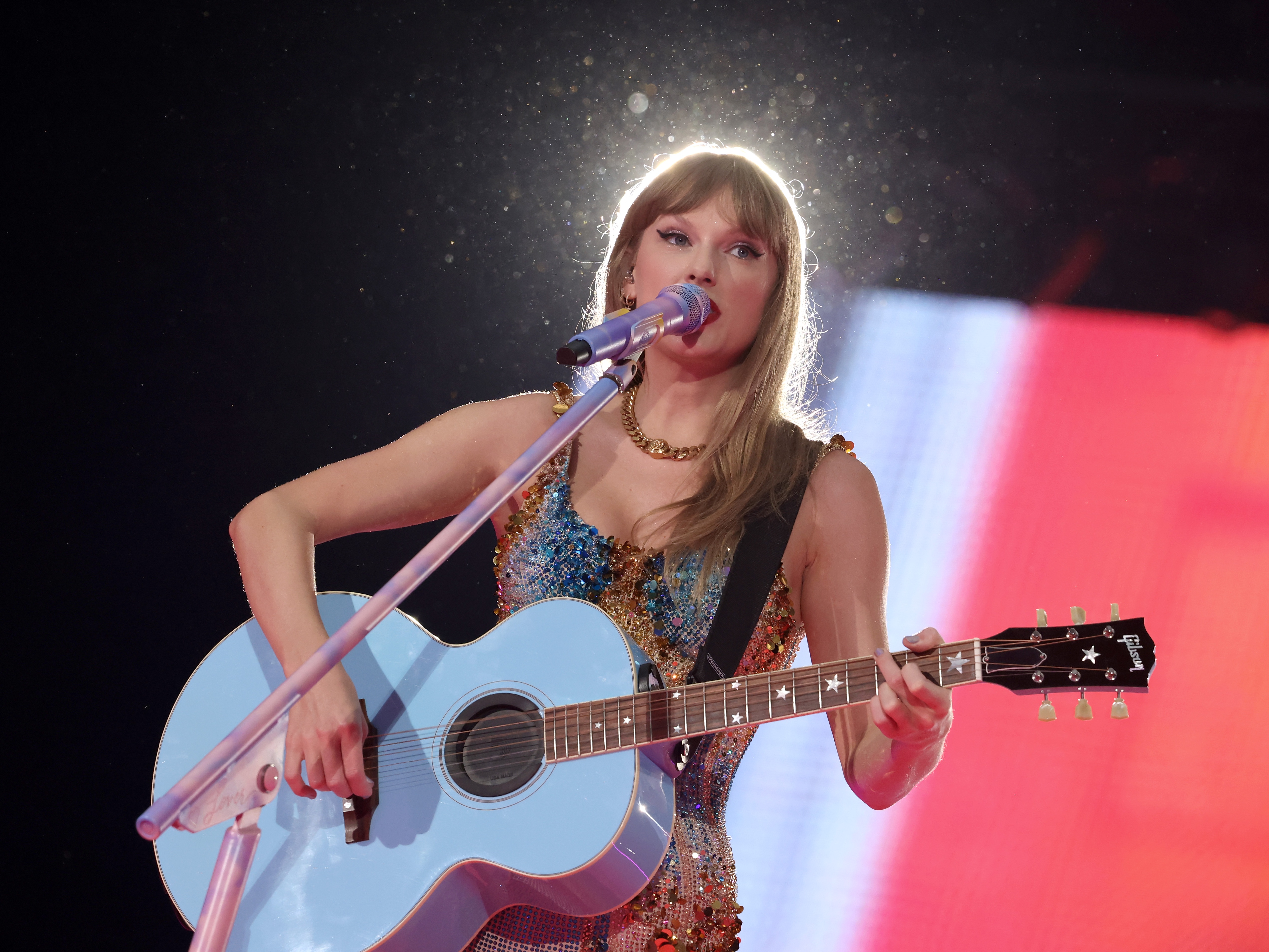 caption: Taylor Swift performs onstage during the European leg of her Eras Tour on July 5 in Amsterdam. 