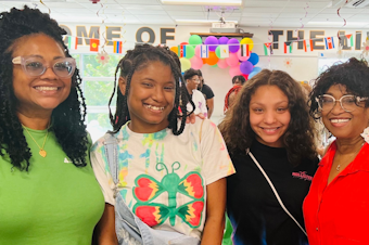 caption: Taniya Guster (second from left) poses with Najmah Messiah (far left), Tylicia Messiah (second from right) and Aaliyah Messiah after a fashion show at Taniya’s high school, Why Not You Academy, in March 2023.