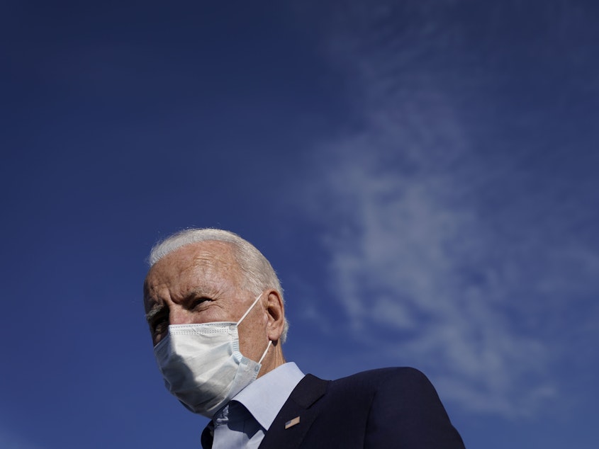caption: Democratic presidential nominee and former Vice President Joe Biden speaks to reporters before boarding his campaign plane at Duluth International Airport on September 18, 2020 in Duluth, Minn.