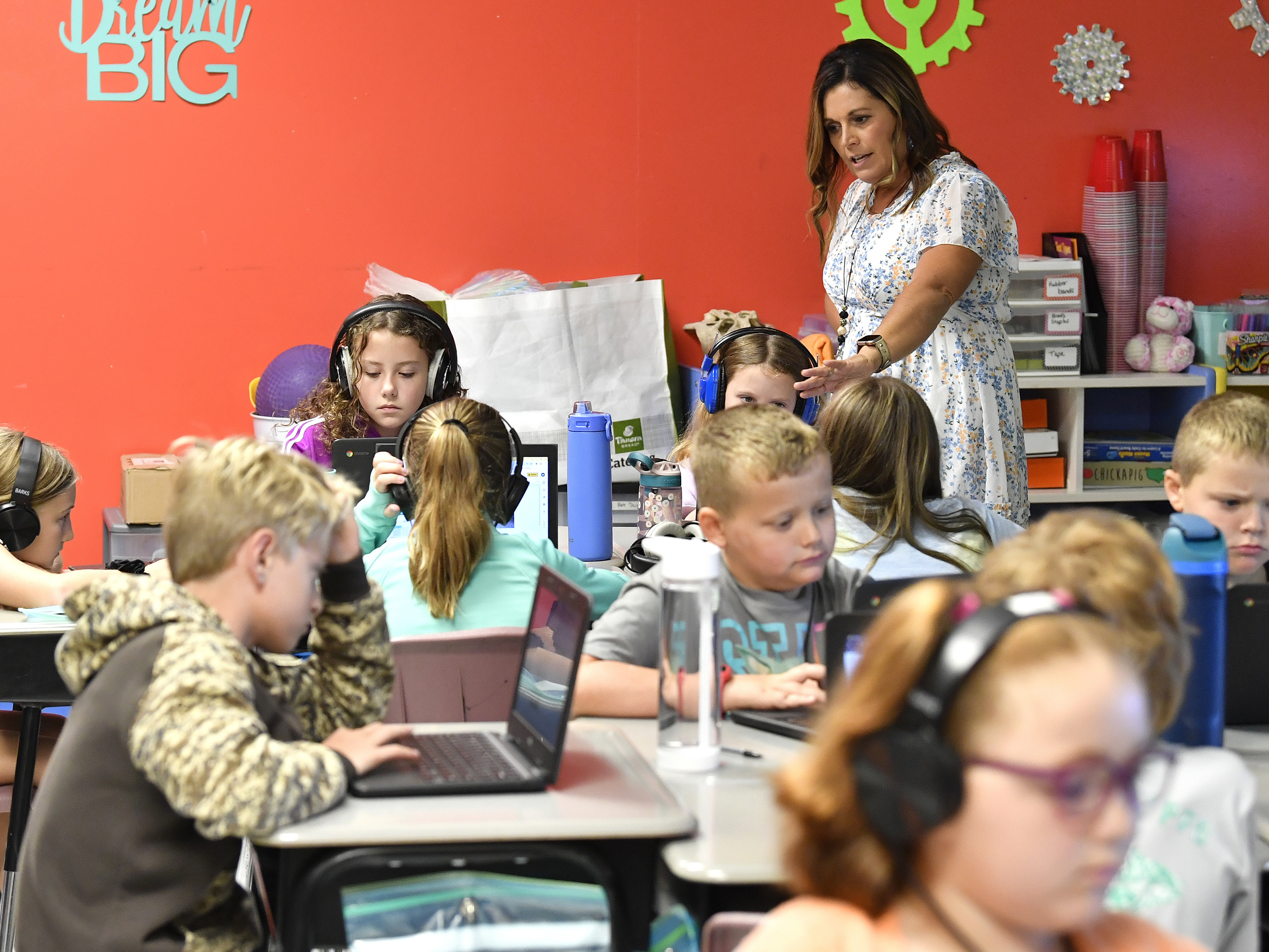caption: Angela Pike watches her fourth grade students at Lakewood Elementary School in Cecilia, Ky., as they use their laptops to participate in an emotional check-in at the start of the school day, Thursday, Aug. 11, 2022.