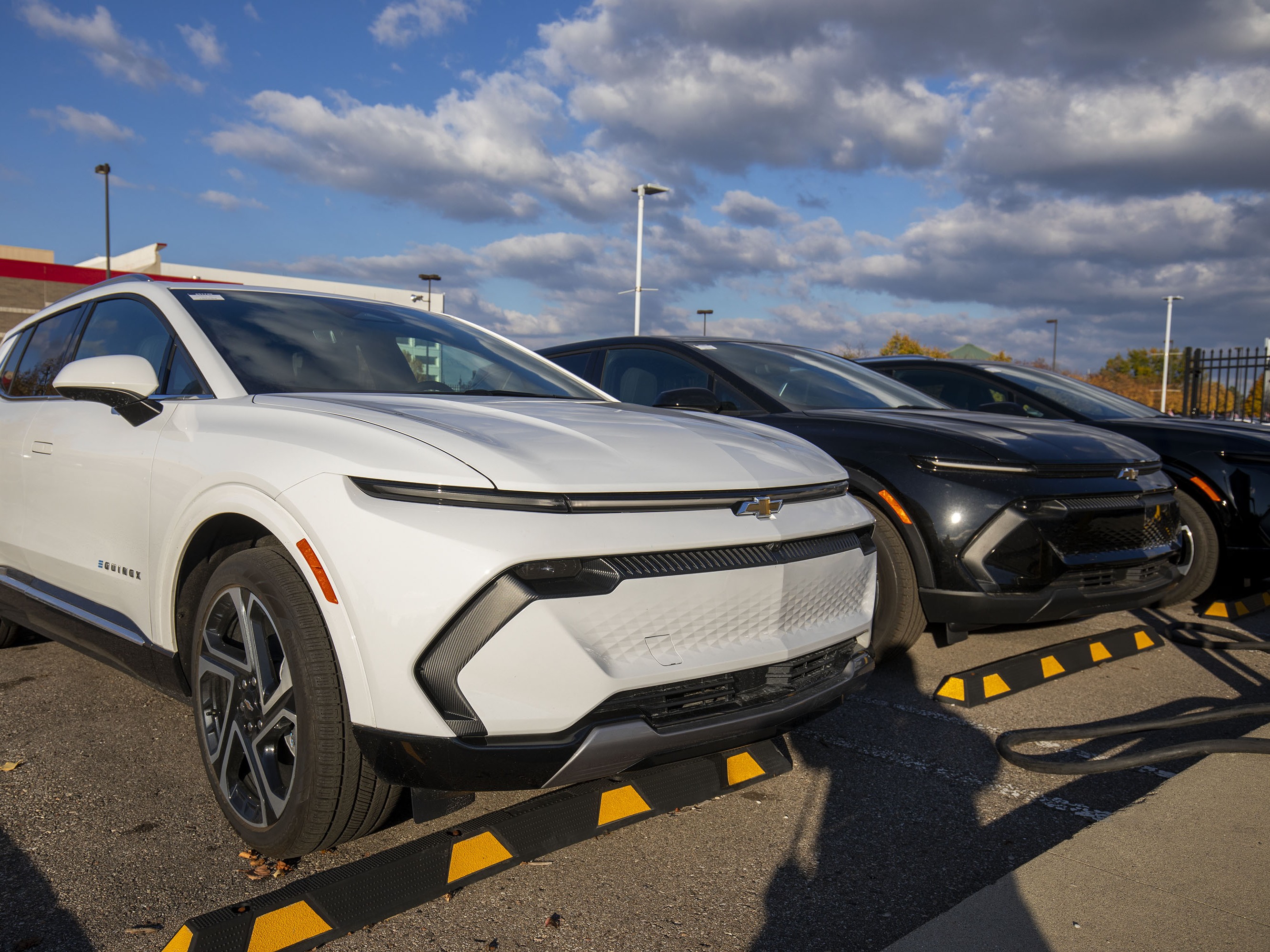 caption: Chevrolet Equinox EVs are shown for sale at a Chevrolet dealership in Southfield, Mich., on Oct. 29. General Motors announced stronger-than-expected quarterly earnings this month, but also announced it will be laying off 3,300 hourly employees around the country at plants that make electric vehicles and batteries.