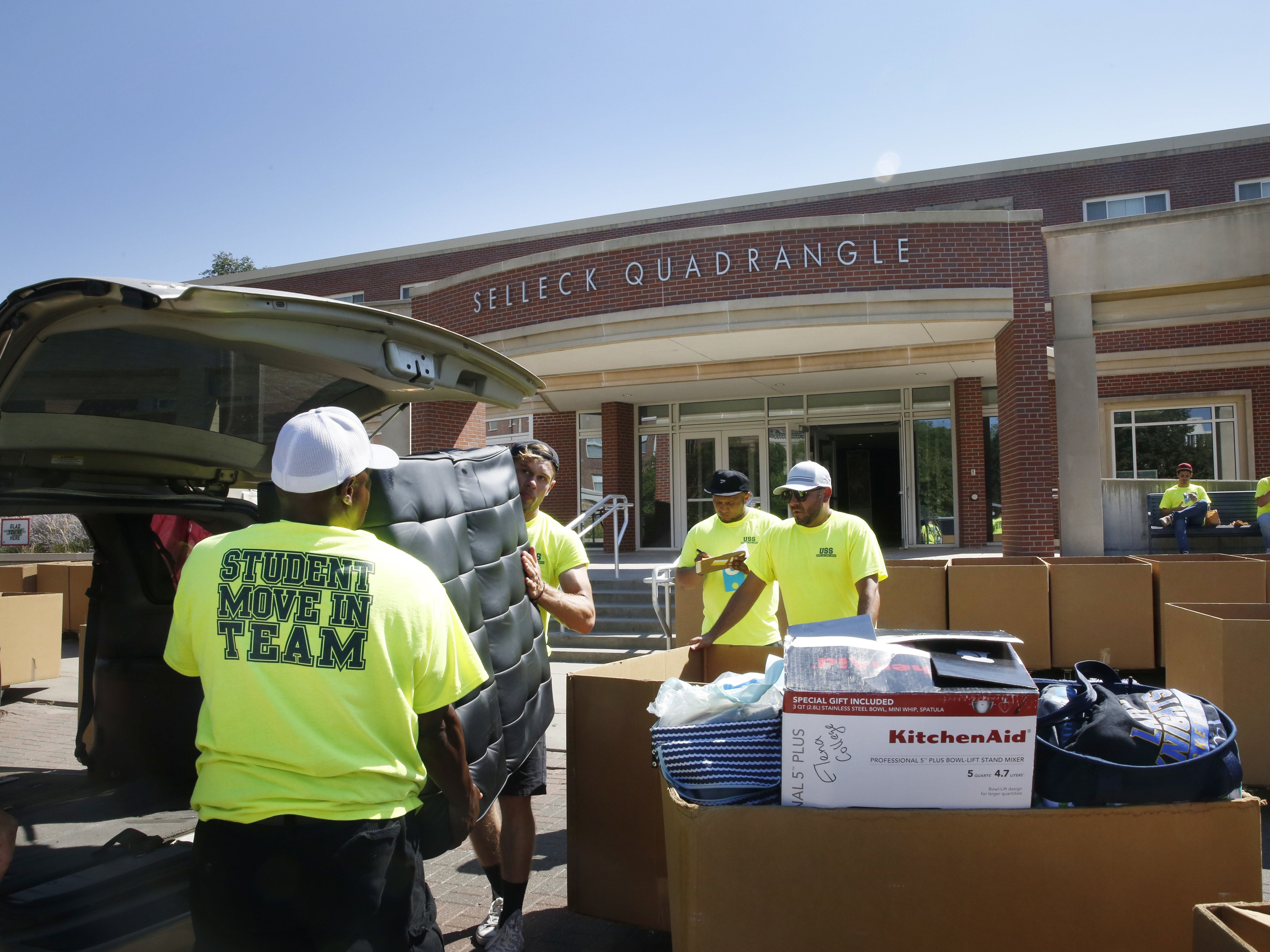 caption: Workers help students move in to Selleck Hall, at the University of Nebraska–Lincoln.