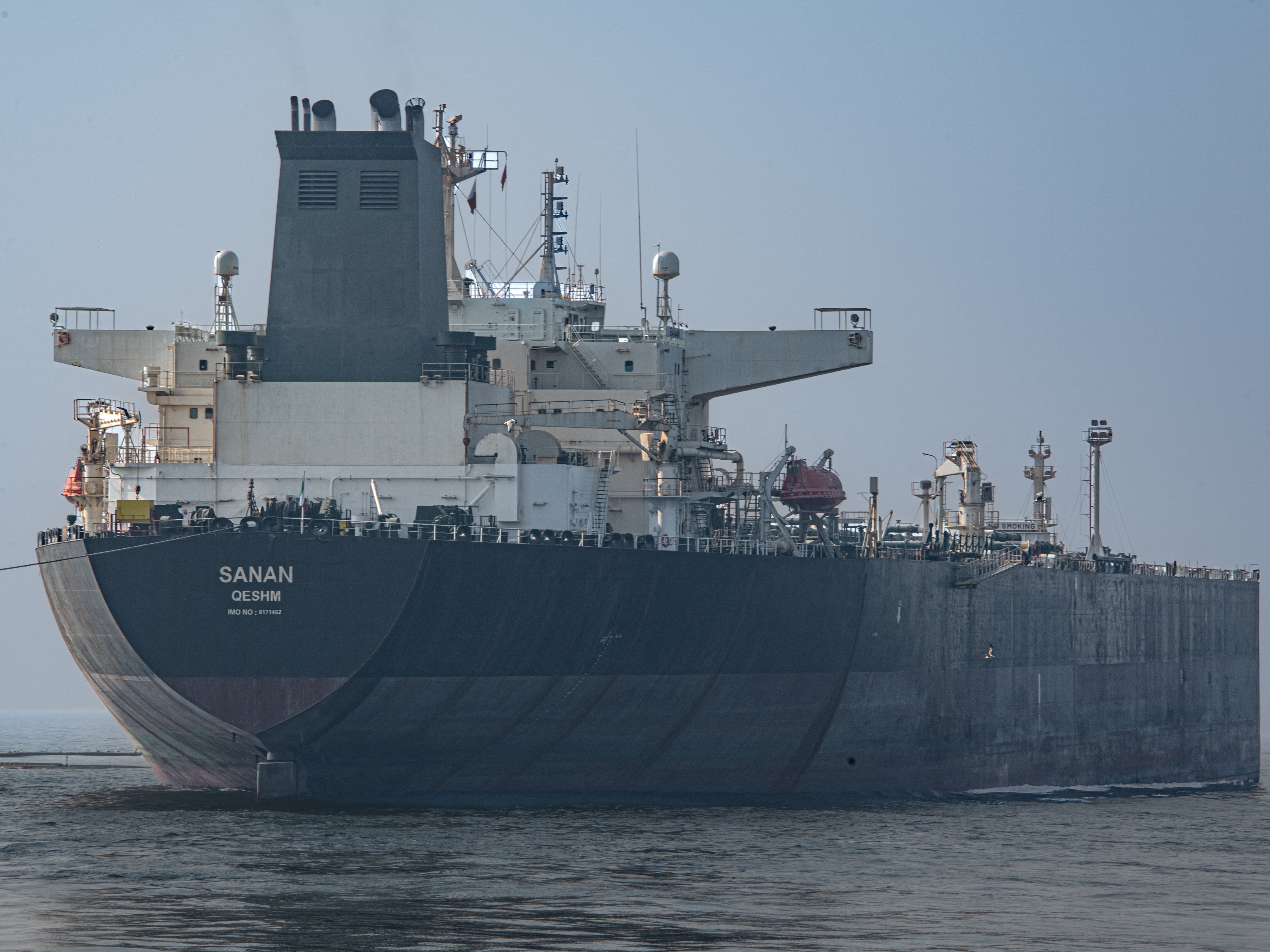 caption: The crude oil tanker, Sanan, is seen in coastal waters near Bandare Asaluyah, Iran, on January 27, 2026.
