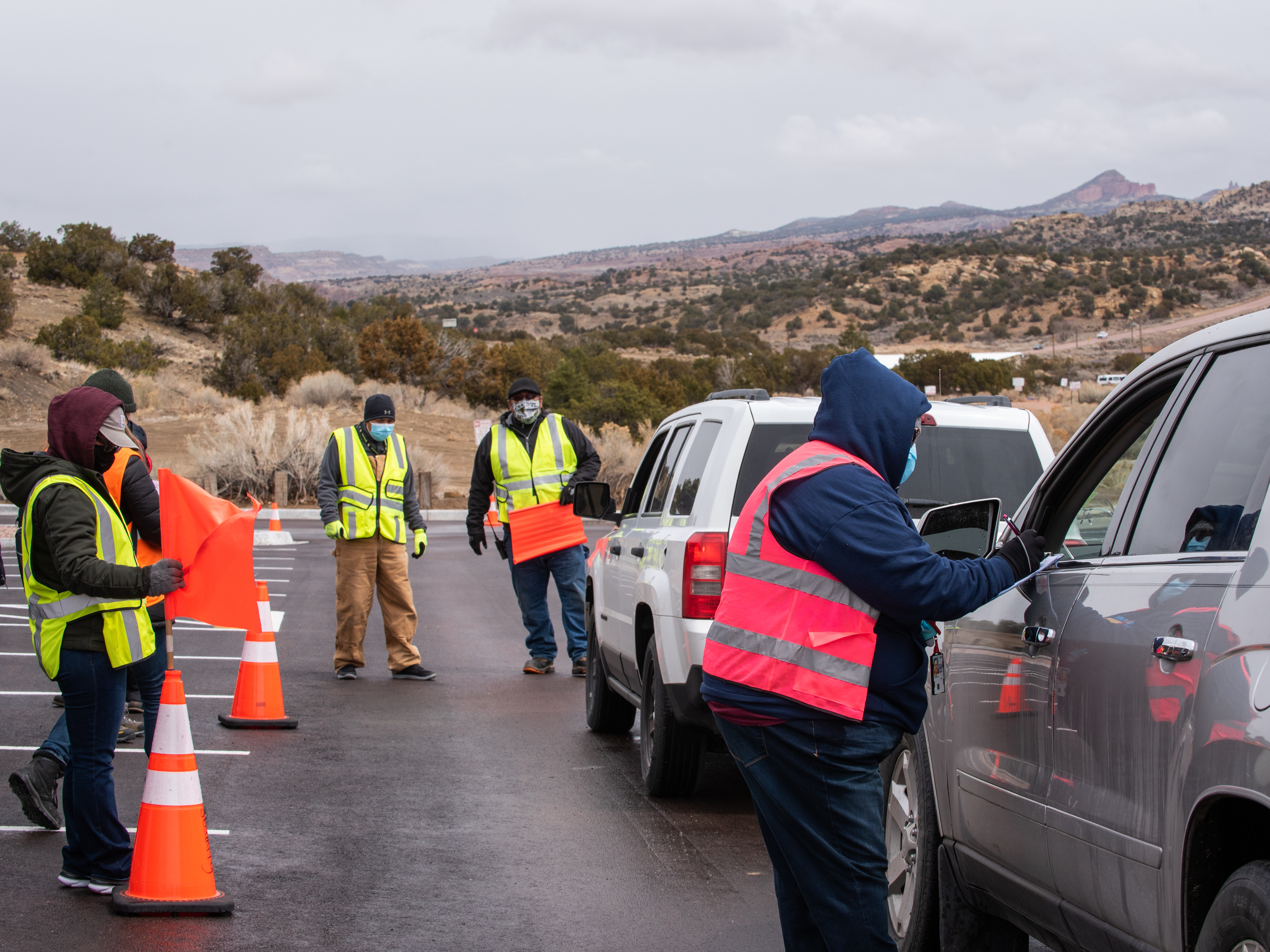 caption: Workers greet arrivals at a drive-in vaccination site at University of New Mexico's Gallup campus in Gallup, N.M., on March 23. The Navajo Nation has vaccinated more than half of its adult population, outpacing the U.S. national rate.