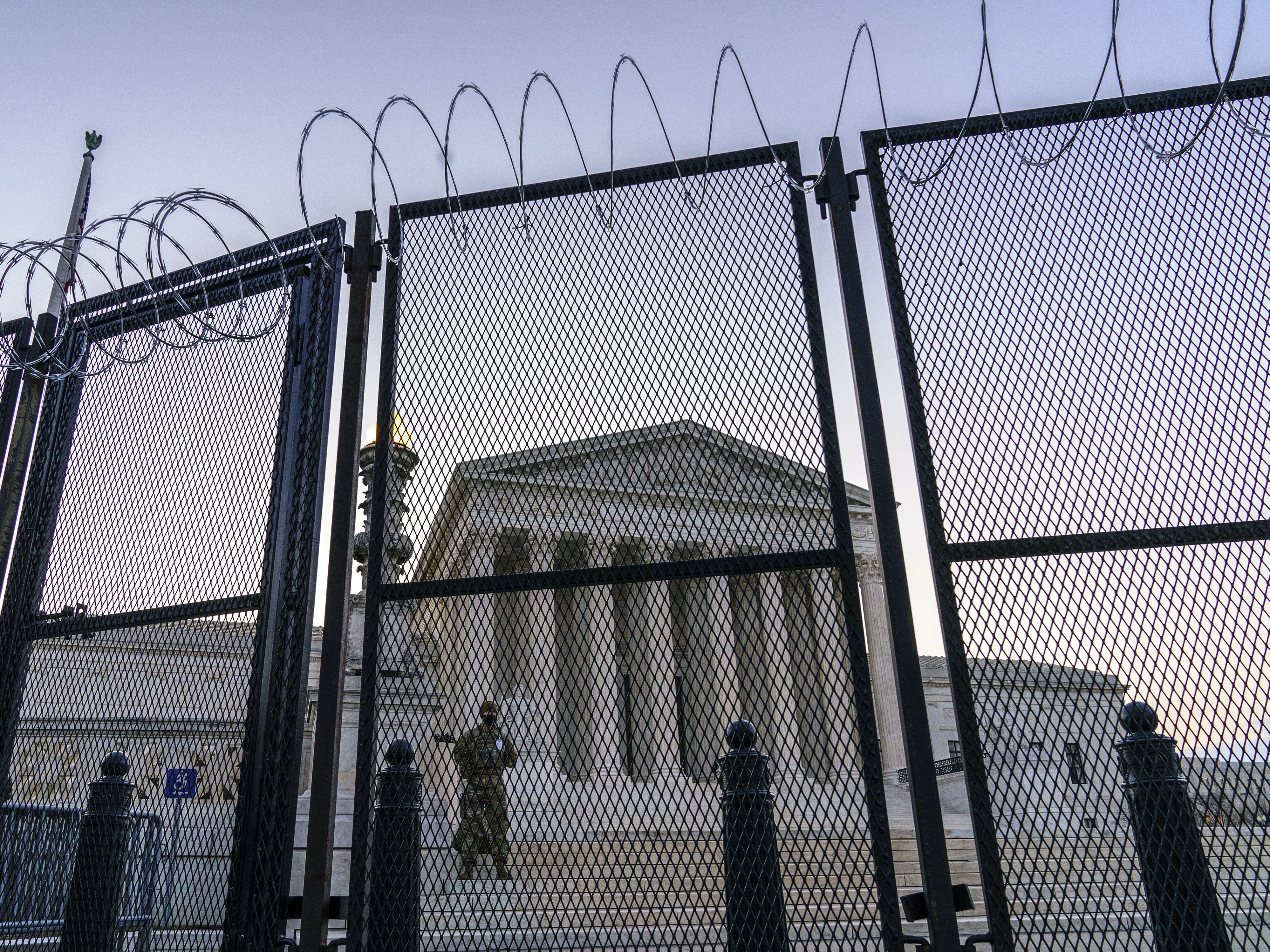 caption: National Guard troops keep watch Thursday at the Supreme Court.