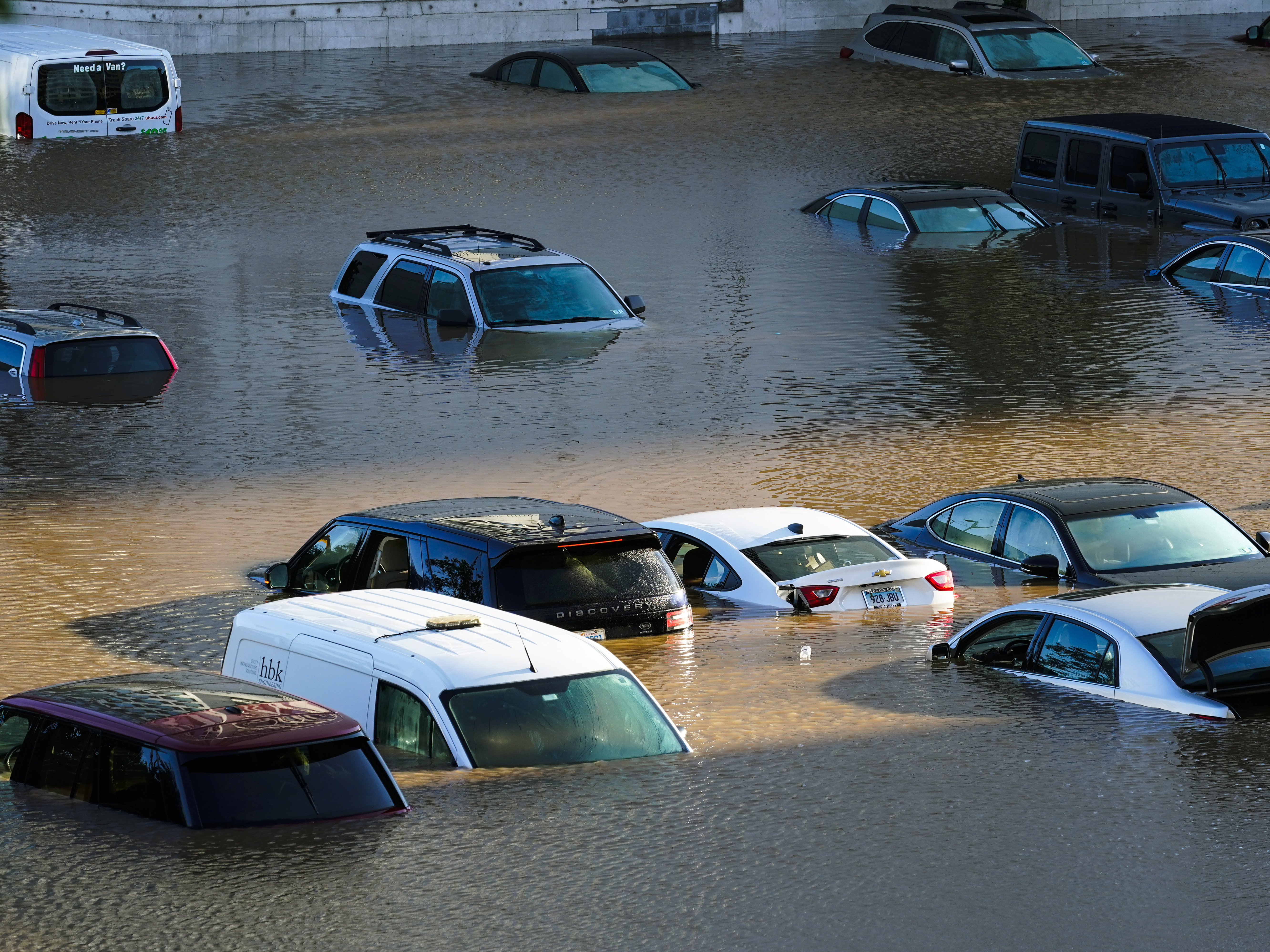 caption: In 2021, Hurricane Ida cut a path of destruction from the Gulf Coast to the Northeast. Vehicles parked in Philadelphia were submerged after the storm brought torrential rain.