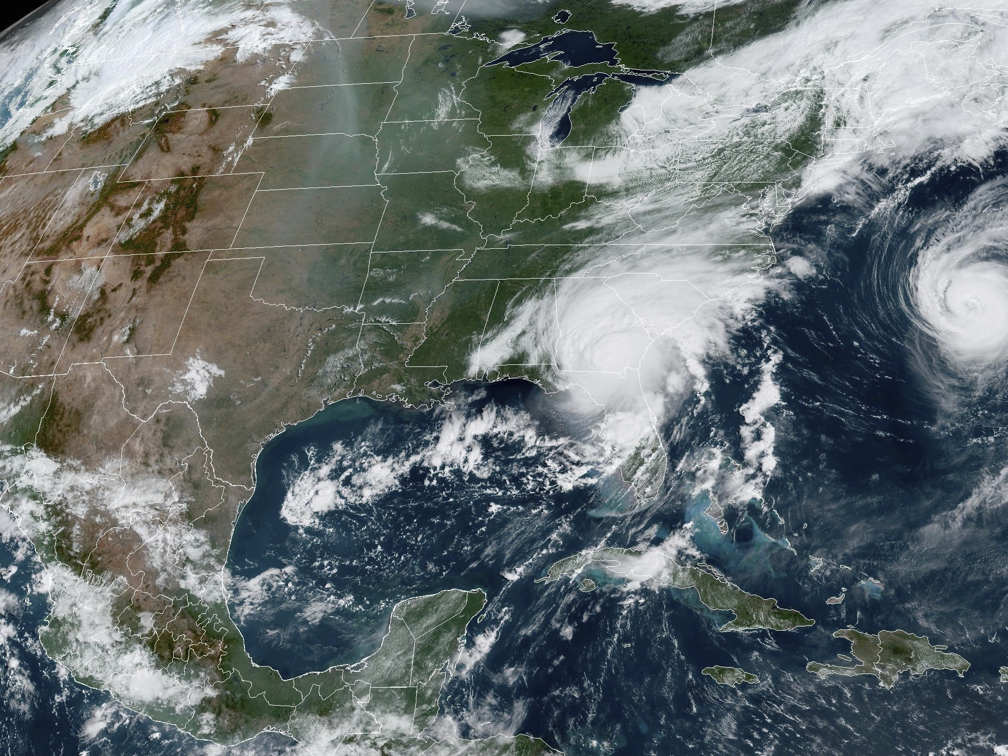 caption: A satellite image provided by the National Oceanic and Atmospheric Administration shows Hurricane Idalia, center, over Florida and crossing into Georgia, and Hurricane Franklin, right, as it moves along off the East coast of the U.S., on Aug. 30, 2023.