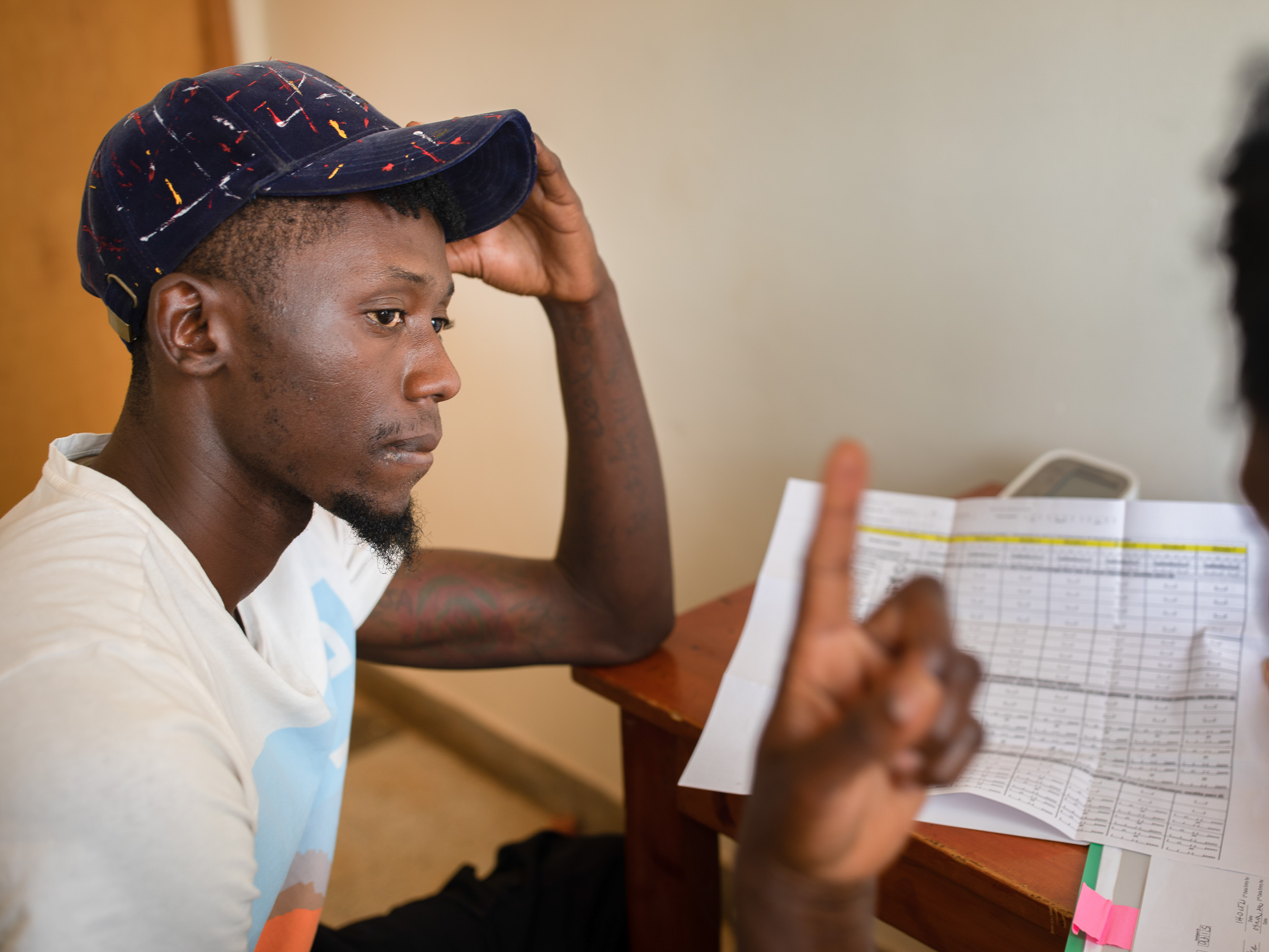 caption: A nurse enrolls a participant in an HIV vaccine trial in Masaka, Uganda, an African-led project.
