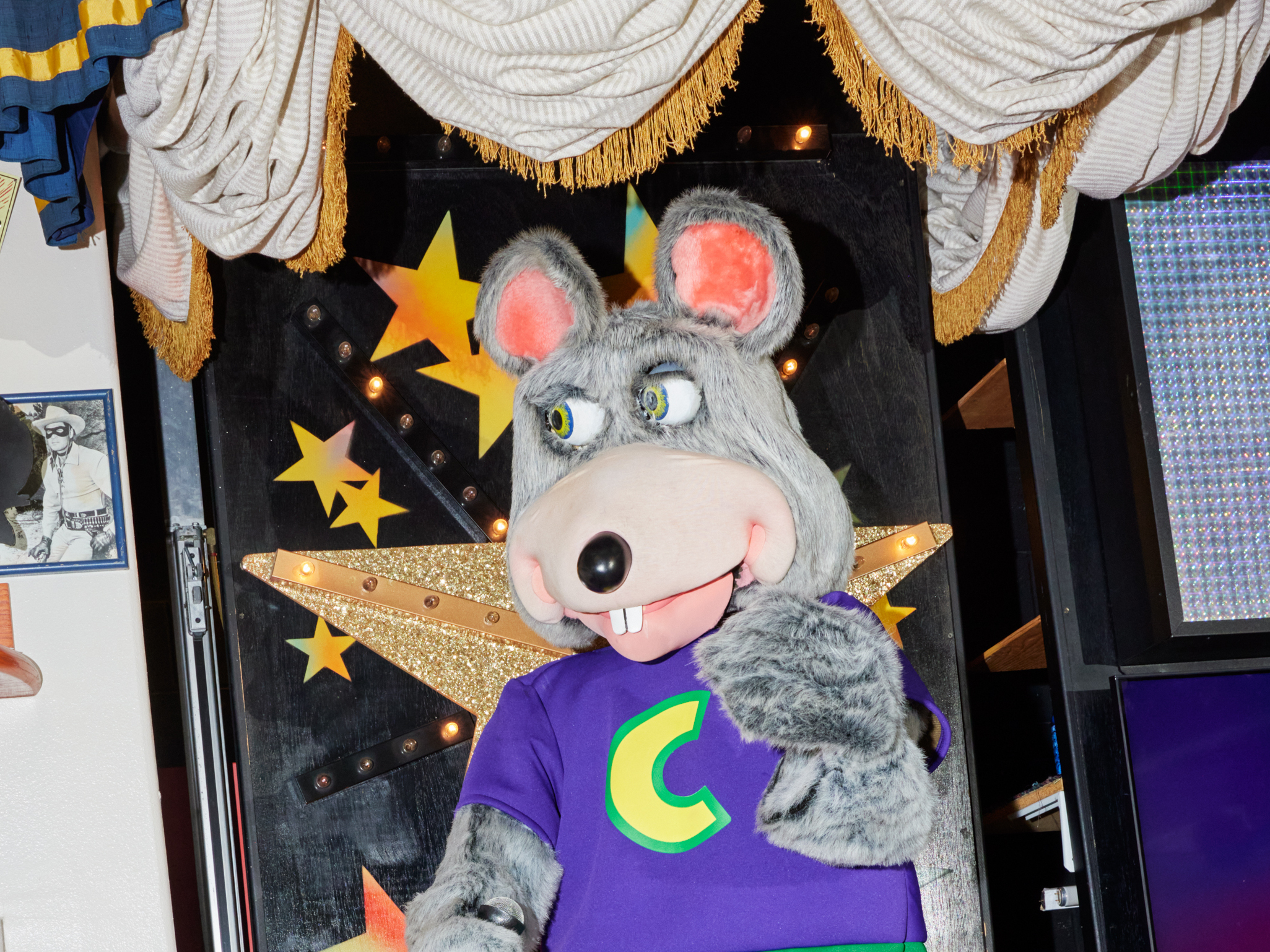 caption: Chuck E. Cheese, the frontman for the animatronic Munch's Make Believe Band at the Chuck E. Cheese location in Northridge, Calif. This animatronic band is the last remaining one in the United States as locations remodel in favor of screens and interactive dance floors.