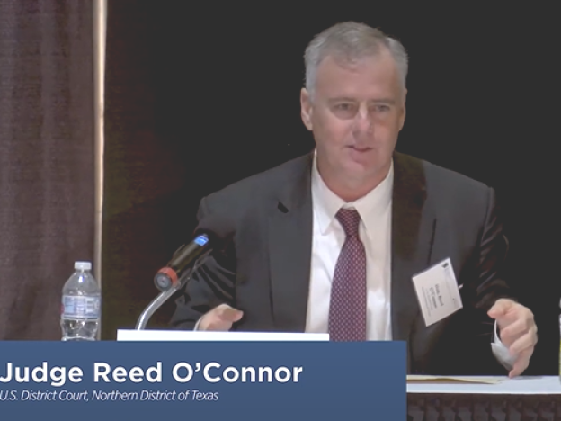 caption: U.S. Federal Judge Reed O'Connor has been a longtime active member of the Federalist Society. In 2018, he spoke on a panel at the annual Texas Chapters Conference.