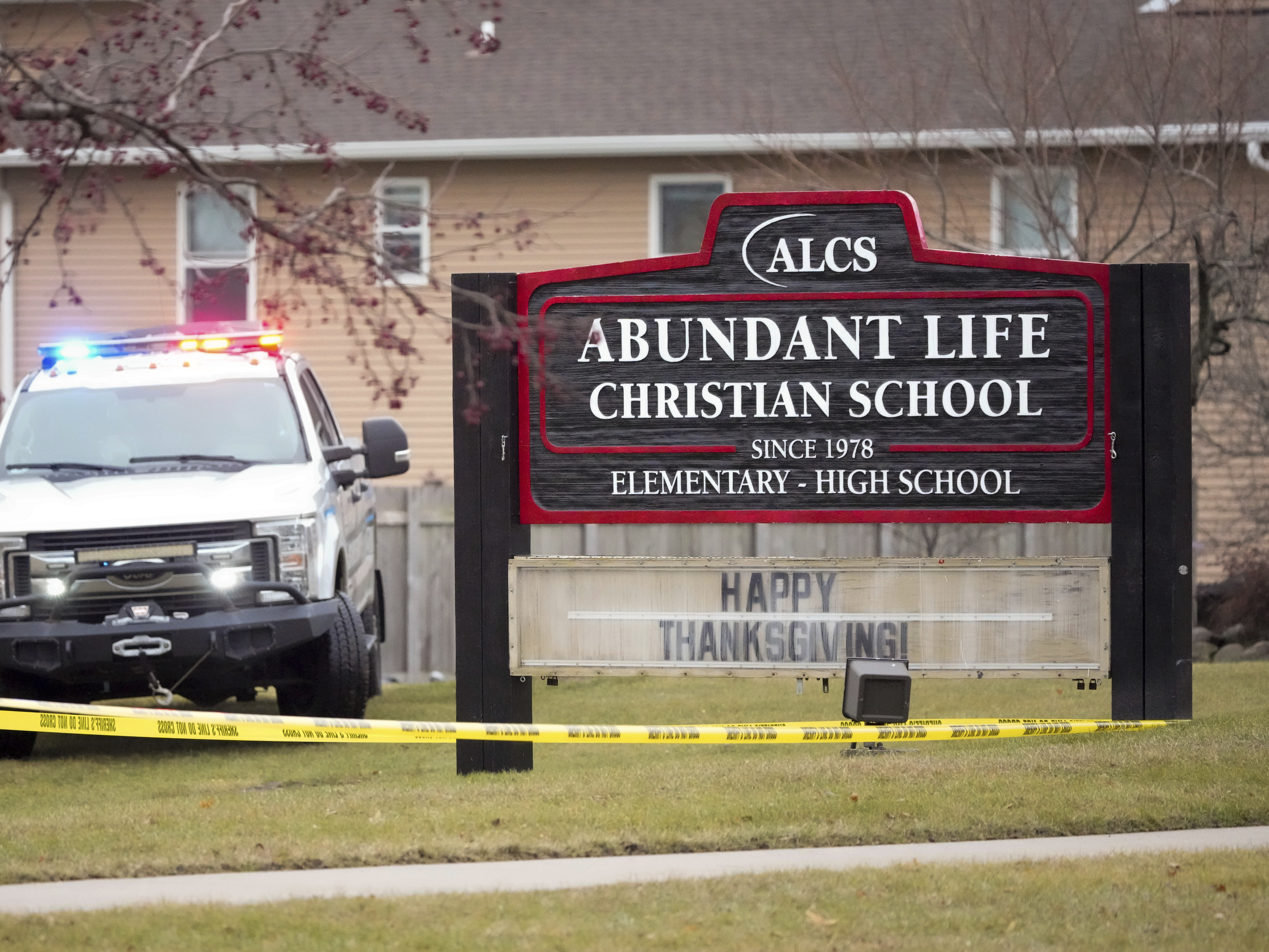 caption: An emergency vehicle is parked outside the Abundant Life Christian School in Madison, Wis., following a shooting on Dec. 16.