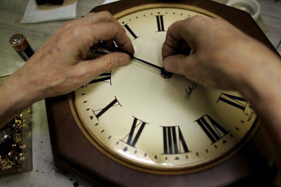 caption: Howard Brown repairs a clock at Brown's Old Time Clock Shop in Plantation, Florida. (Joe Raedle/Getty Images)