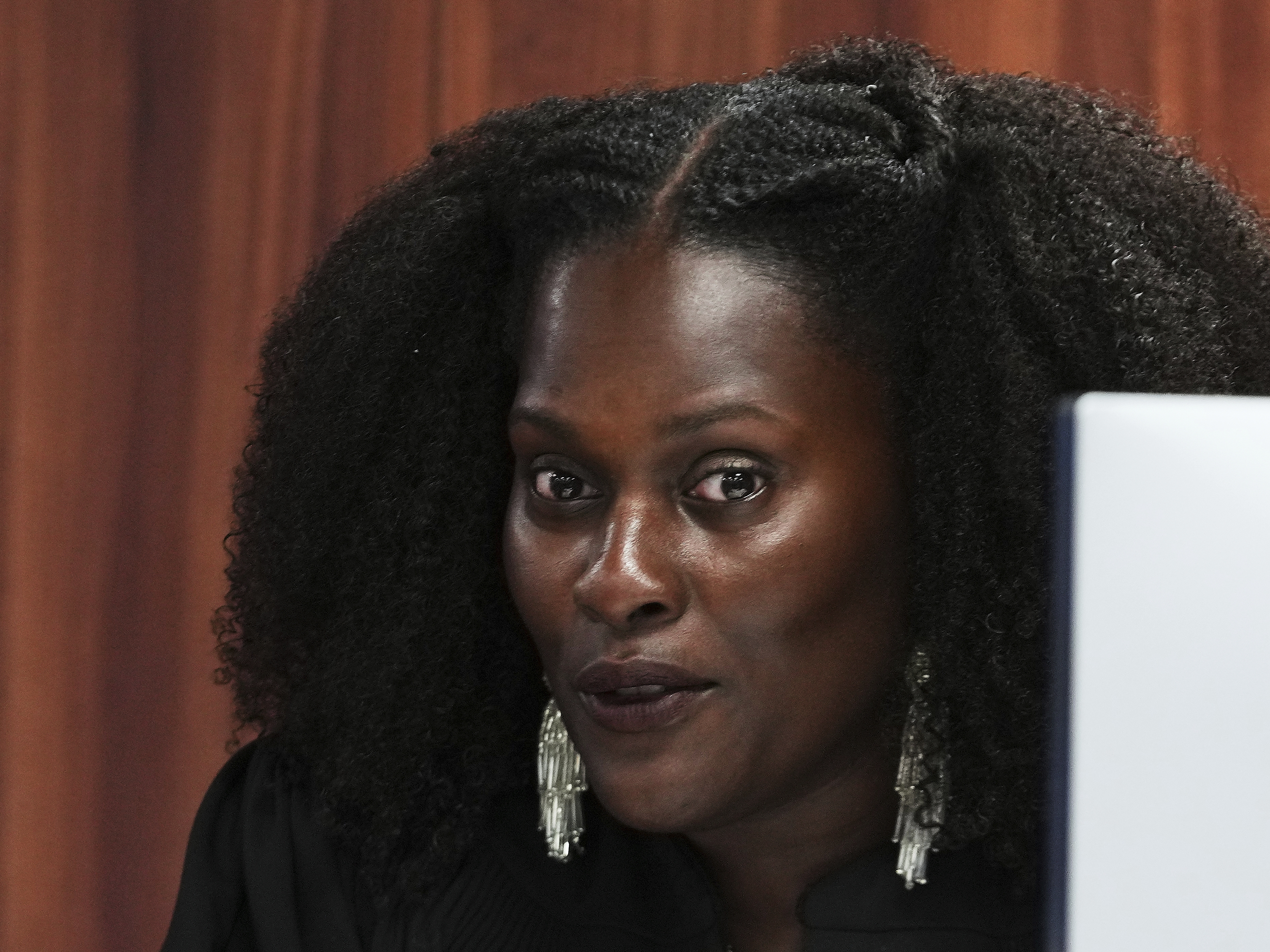 caption: Michigan District Court Judge Kristen Simmons speaks Tuesday in Lansing while dismissing the criminal cases against 15 people accused of acting falsely as electors for Donald Trump in the 2020 election.