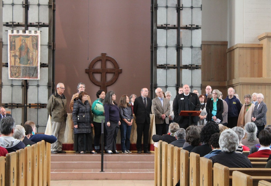 caption: Faith communities gather on May Day 2017 at St. Mark's Cathedral in Seattle's Capitol Hill neighborhood to declare their support for immigrants and refugees.