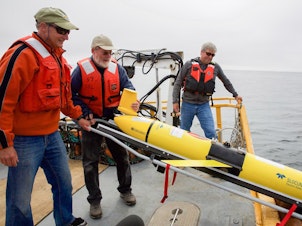 caption: Oregon State University oceanographer Jack Barth deploys a glider that will spend weeks at sea collecting data on everything from dissolved oxygen levels to temperature. "When we used to think about hypoxia in the ocean, we think about little areas. But now what we're looking at is...out in the ocean, there's low oxygen...all along the coast," he says.