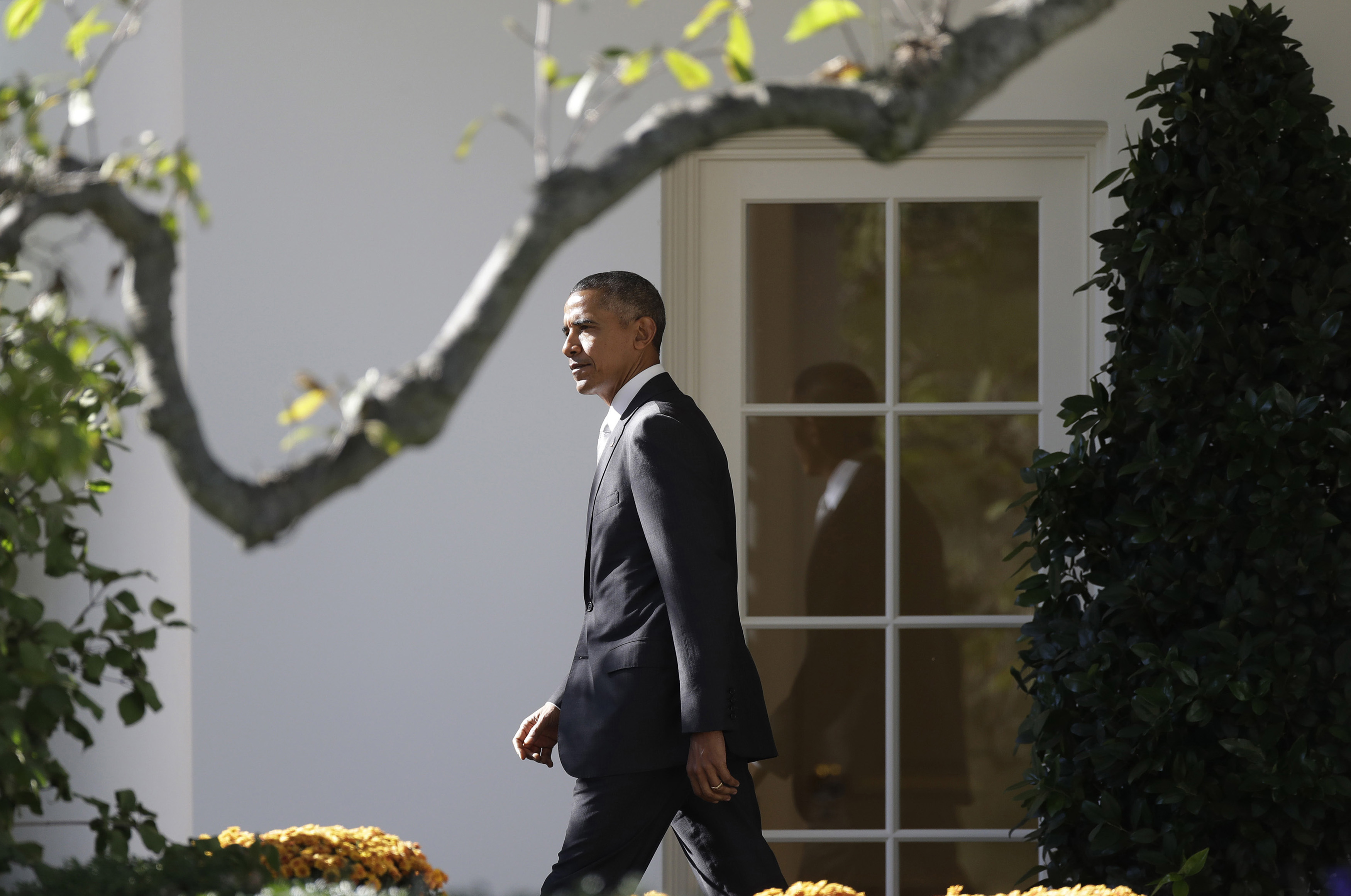 caption: President Barack Obama walks from the Oval Office and across the South Lawn of the White House in Washington, Friday, Oct. 28, 2016, before boarding Marine One helicopter for the short flight to Andrews Air Force Base, Md., en route to Florida to speak at a Hillary for America campaign event. (Carolyn Kaster/AP)