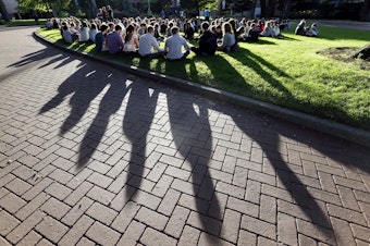 caption: Students from Seattle Pacific University gather in a prayer circle after the shooting on June 5, 2014.