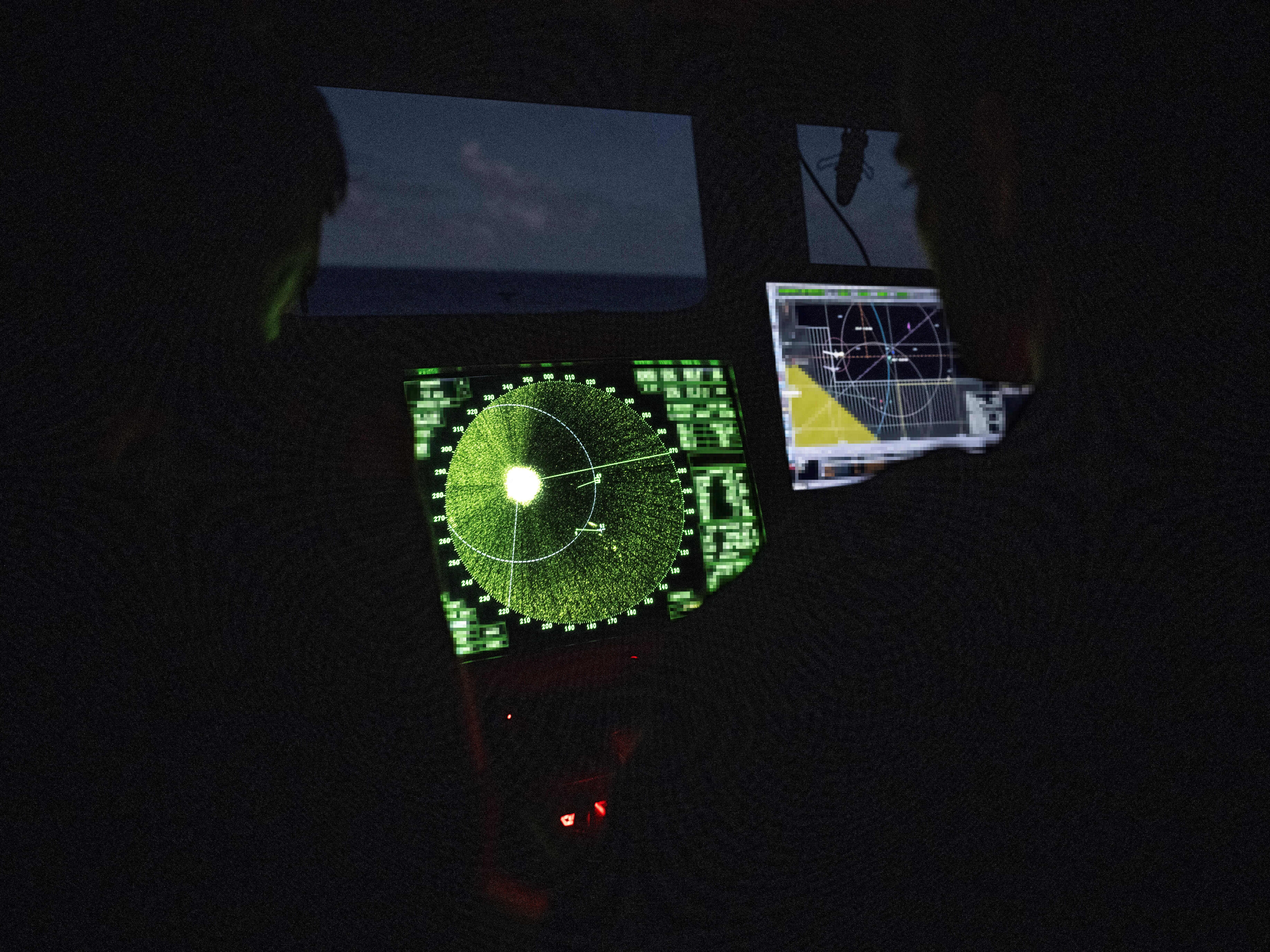caption: Members of the French Navy monitor radar in the control bridge in low light conditions during an anti-drug interception mission by the French surveillance frigate FS Ventose sailing off the French Caribbean island of Martinique, on November 16, 2024.