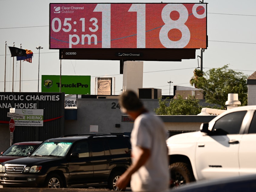 caption: Tens of millions of Americans — including residents in Phoenix, where a billboard displays a temperature of 118 degrees last week — have been living under extreme heat warnings or advisories during the last few weeks. A new study finds climate change is making heat waves more common.