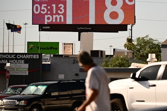 caption: Tens of millions of Americans — including residents in Phoenix, where a billboard displays a temperature of 118 degrees last week — have been living under extreme heat warnings or advisories during the last few weeks. A new study finds climate change is making heat waves more common.